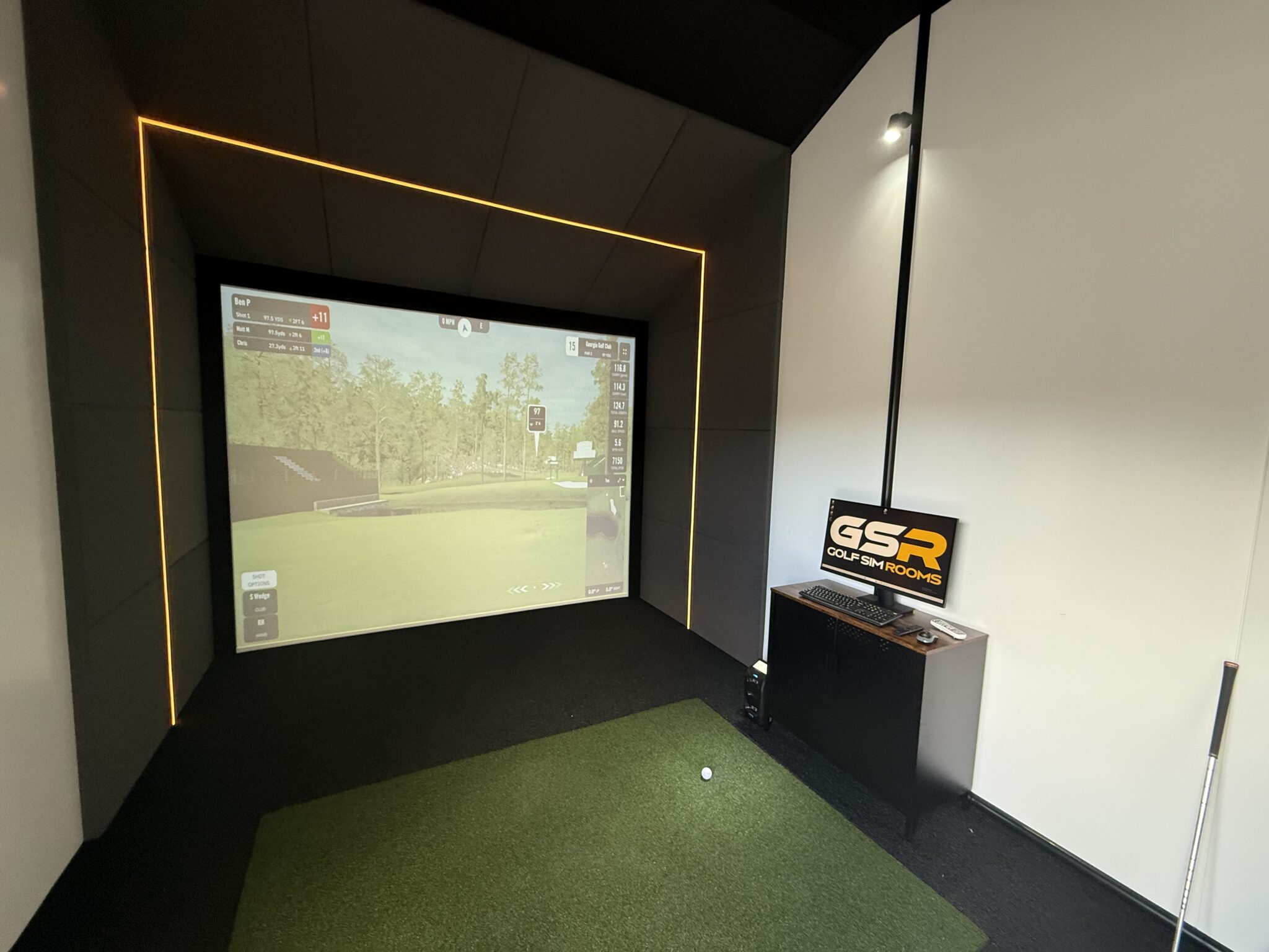 Golf simulator room with impact screen and launch monitor setup