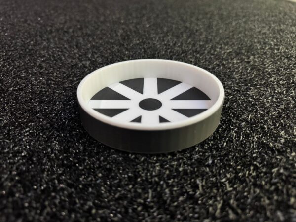 White putting hole insert with 8-spoke pattern viewed from angle showing depth and rim design for artificial putting greens